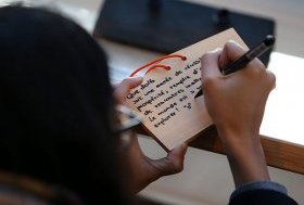 A visitor writes her wish on a wooden plaque at Meiji Shrine in Tokyo, Japan. More than three million people visit the Meiji Shrine during the first three days of the New Year, to pray for their health, economic fortune and wishes to come true