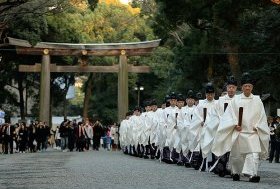Shinto priests walk toward the inner shrine at Meiji Shrine in Tokyo, Japan to attend the shinto ritual preparing for the New Year